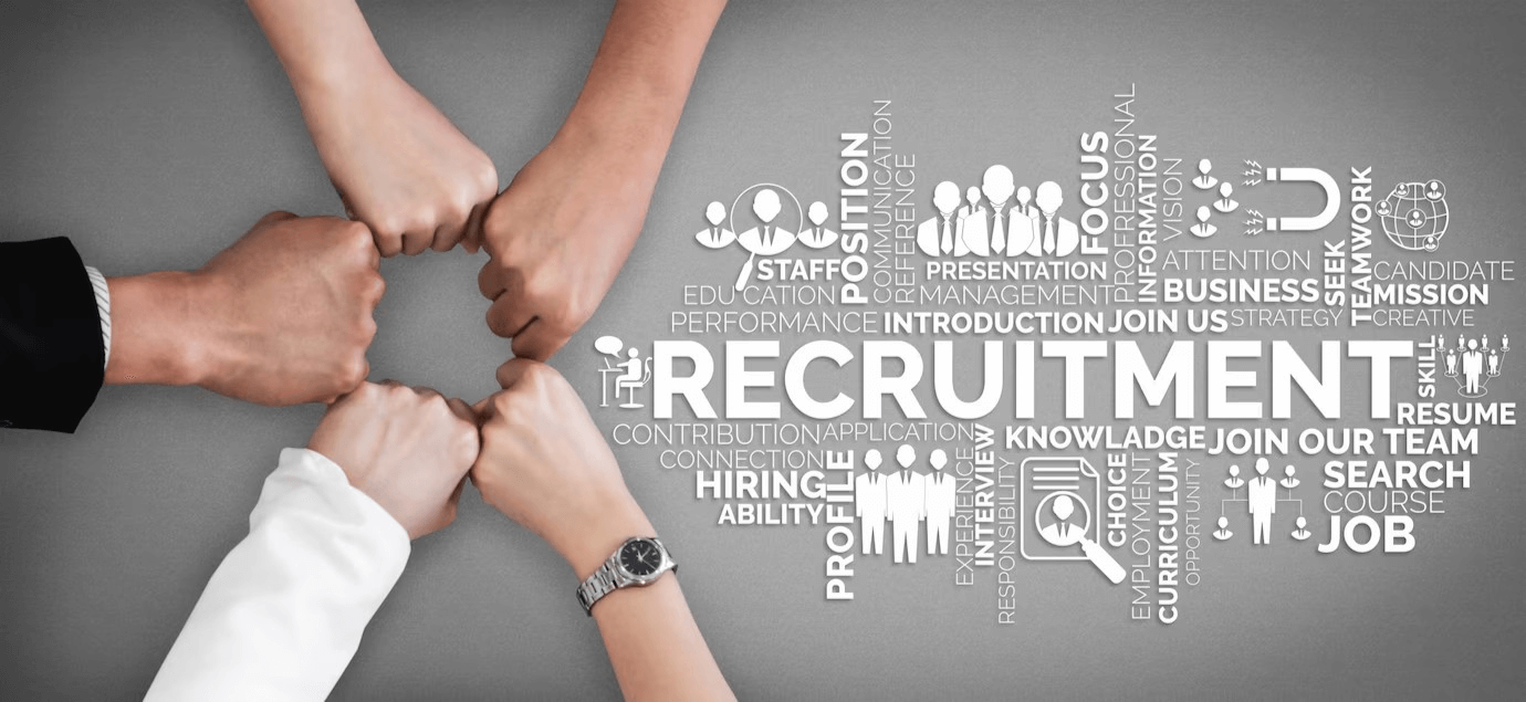The word 'recruitment' is encircled by hands, representing teamwork at a recruitment agency in Dubai.